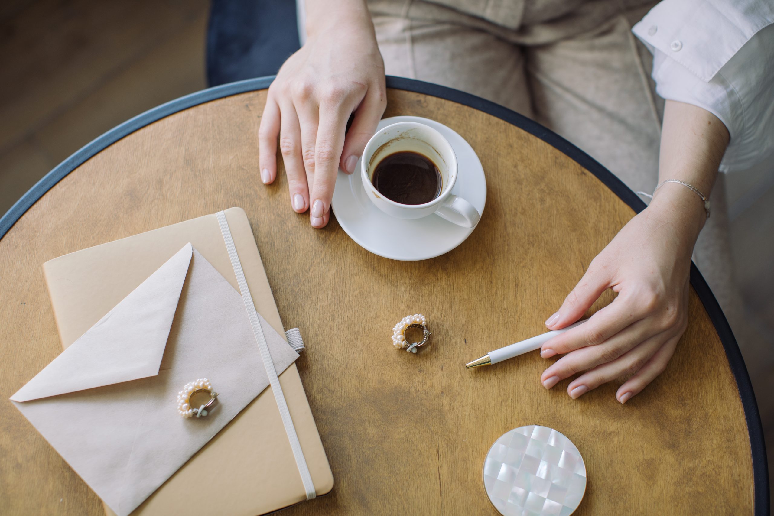 lady writing letter at cafe in paris
